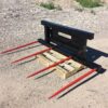 A pallet with forks attached to it on the ground.