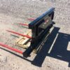 A black and red fork lift on the ground