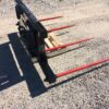 A black and red fork lift on the ground.
