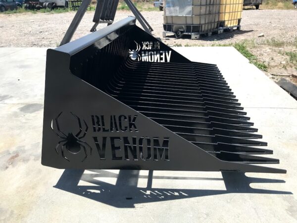 A black venom grill sitting on top of concrete.