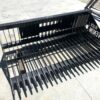 A black metal bench with the word " money " on it.