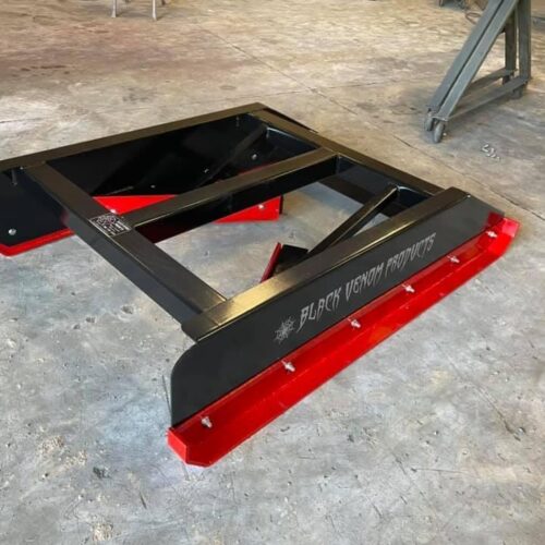 A red and black frame is sitting on the floor.