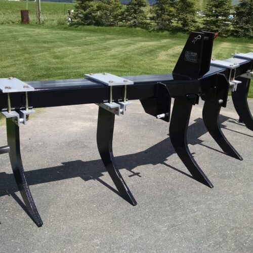 A row of black metal equipment sitting on top of the ground.