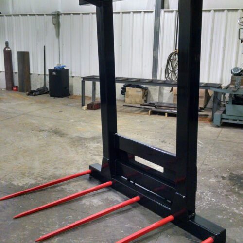 A fork lift with forks attached to it.