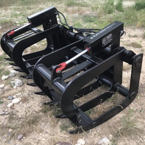 A black metal machine sitting on top of a field.