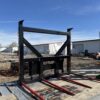A large industrial metal frame with red beams outdoors.
