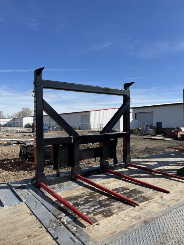 A large industrial metal frame with red beams outdoors.