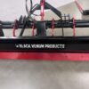 A red agricultural implement labeled 'Black Venom Products' with hydraulic hoses.