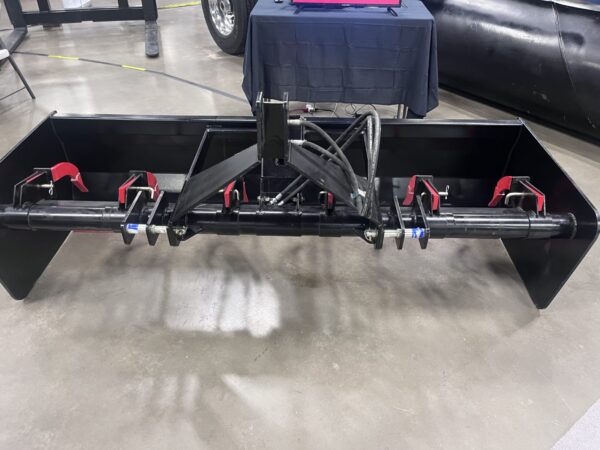 A black metal frame with multiple clamps attached on a concrete floor.